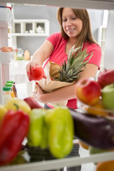 Woman was in purchase and full fridge with healthy food