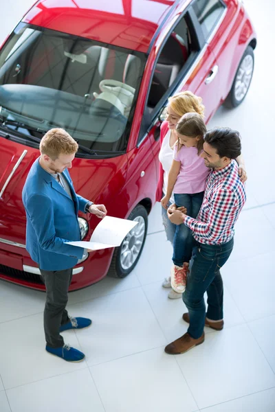 Family with car dealer in car dealership saloon