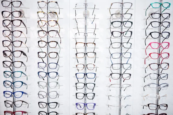 Large selection of frames for eyeglasses on shelf
