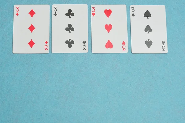 The different suits of a the number 3 card in a deck of cards