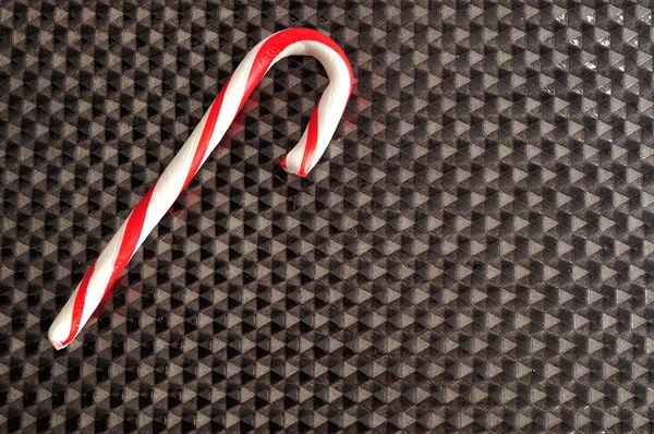 Candy cane isolated against a black background