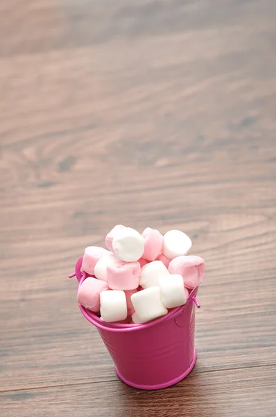 Pink and white marshmallows in a pink container