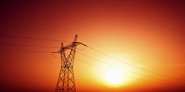 High voltage electric line in sunset