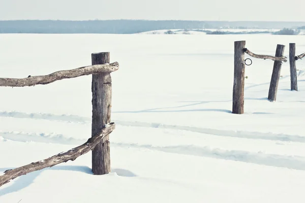 Old wooden fence in snow