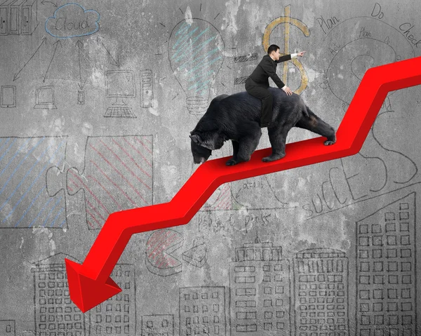 Businessman riding bear on arrow downward trend line with doodle