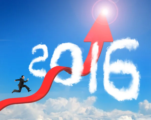 Businessman running arrow upward trend line through 2016 clouds
