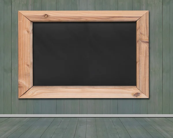 Blank blackboard with wooden frame hanging on wood wall