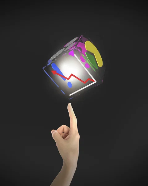 Human finger pointing at illuminated box of business graphs