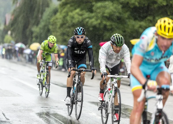 Group of Cyclists Riding in the Rain - Tour de France 2014