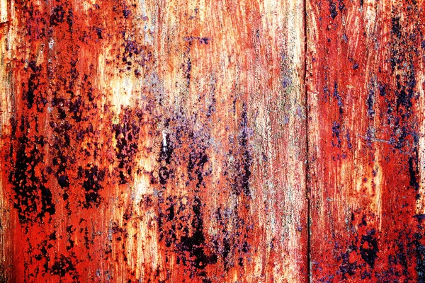 Rusty metal background with cracked paint and aged by time