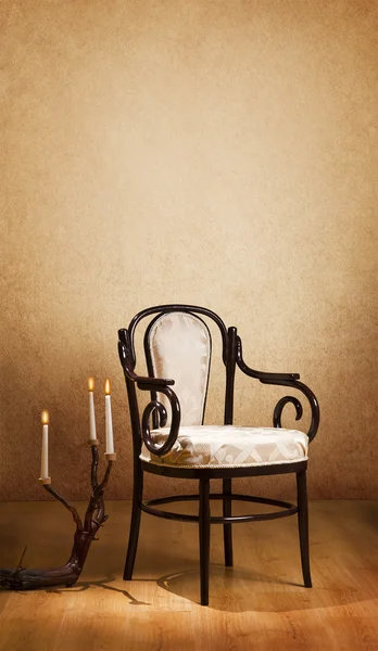 Vintage chair and candles in the dark room