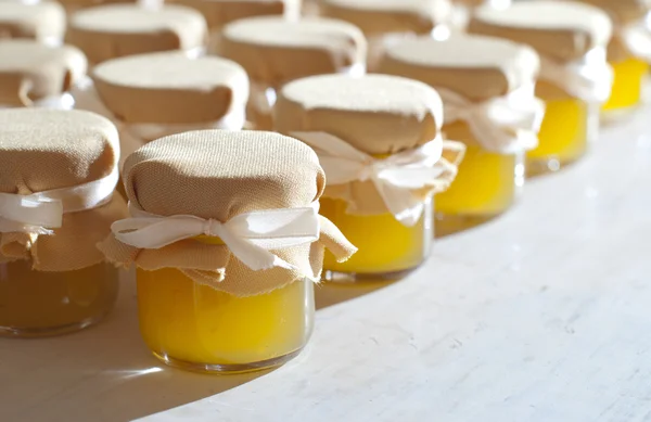 Stock Photo: Jar of honey on white table jam confiture marmalade pozzy  make conserve preserve