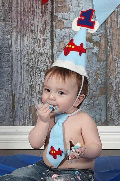 Little Boy eating birthday cake