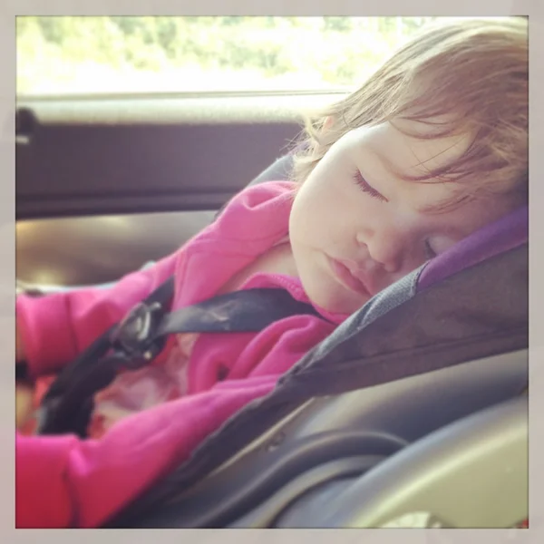 Sweet baby girl sleeping in car seat