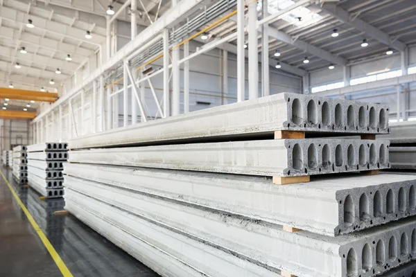 Stack of precast reinforced concrete slabs in a house-building factory workshop