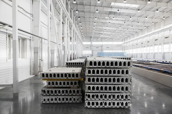 Stack of precast reinforced concrete slabs in a house-building factory workshop