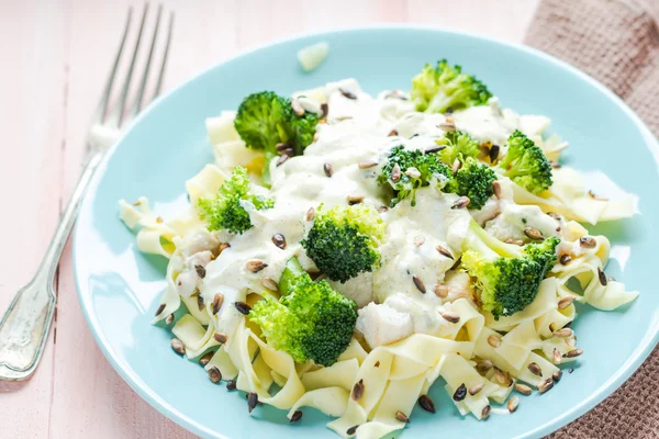 Pasta dish broccoli sauce sunflower seeds