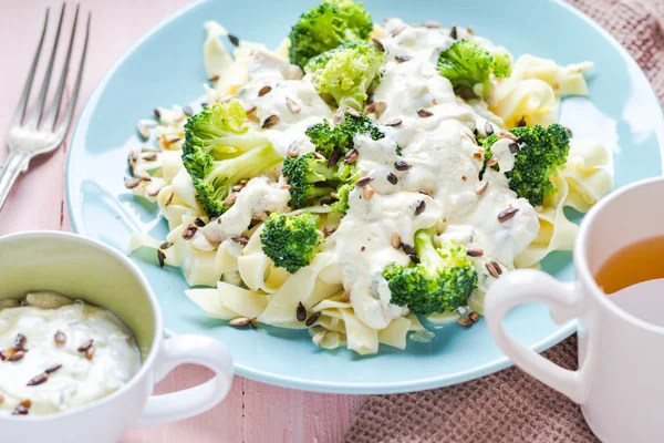 Pasta dish broccoli sauce sunflower seeds