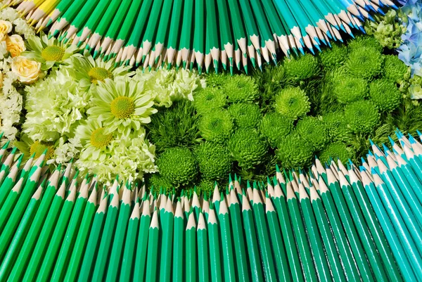 Background of colorful flowers and pencils