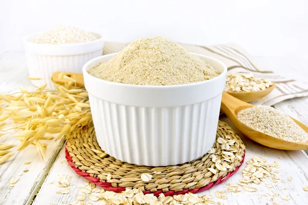 Flour oat in white bowl on board