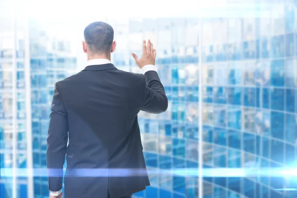 Backview of businessman waving hand