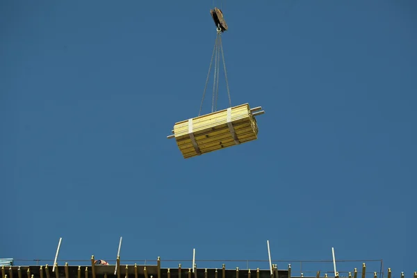 Crane lifts load