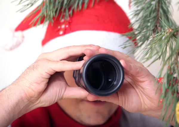 Santa looking through binoculars