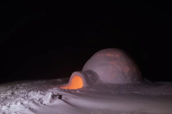 House of snow in mountains at night