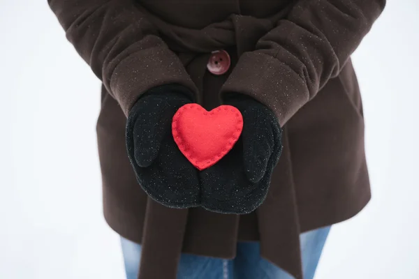 Red decorative heart in the hands