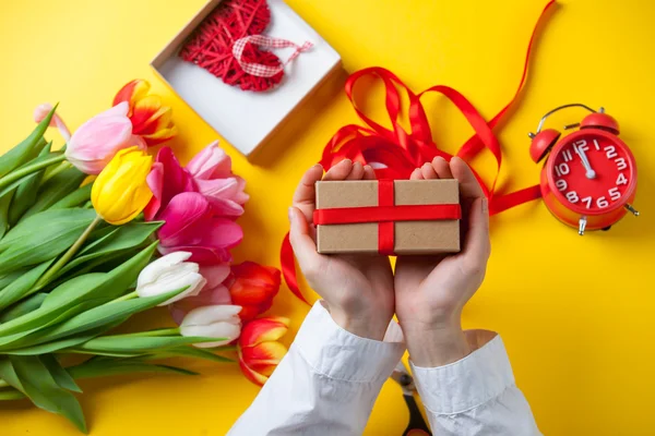 Female hands are holding a gift