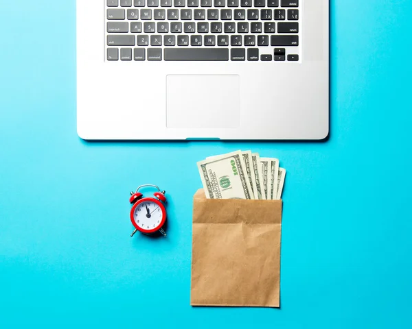 Clock, money and laptop