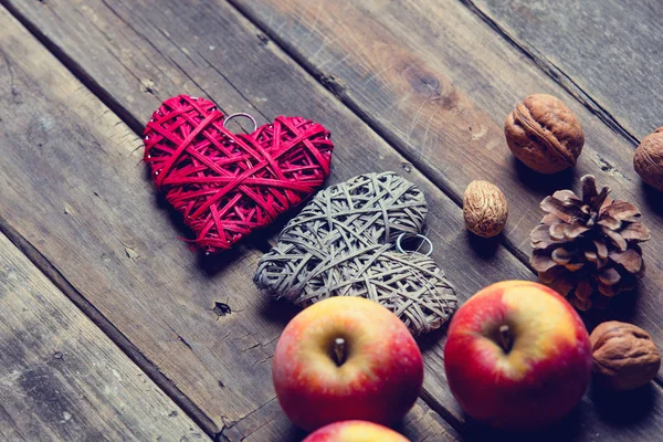 Apples, heart shaped toys, fir-cones and nuts