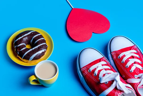 Donut, gumshoes, cup of coffee and heart