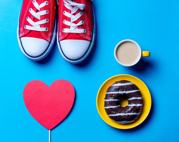 Donut, gumshoes, cup of coffee and heart