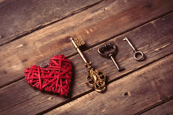 heart shaped toy and different vintage keys