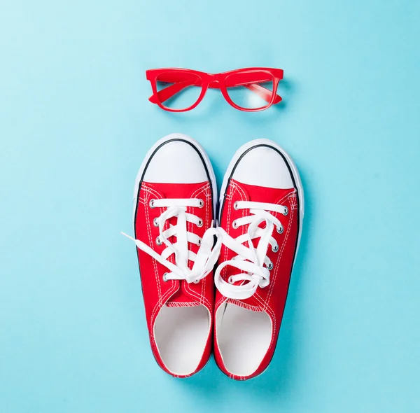 Gumshoes with white shoelaces and glasses
