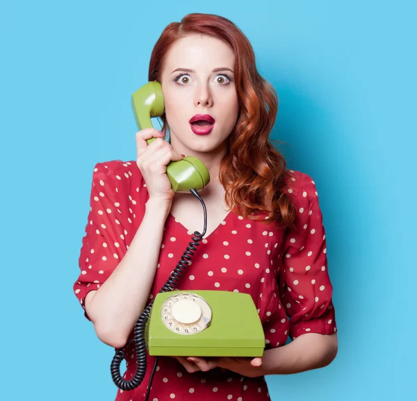 Girl in dress with green dial phone