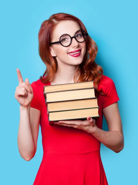 Girl in red dress with books