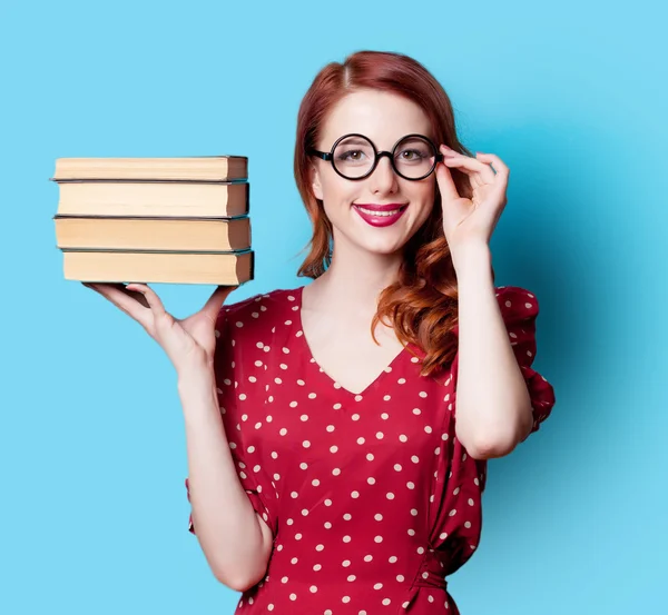 Girl in red dress with books