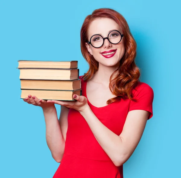 Girl in red dress with books