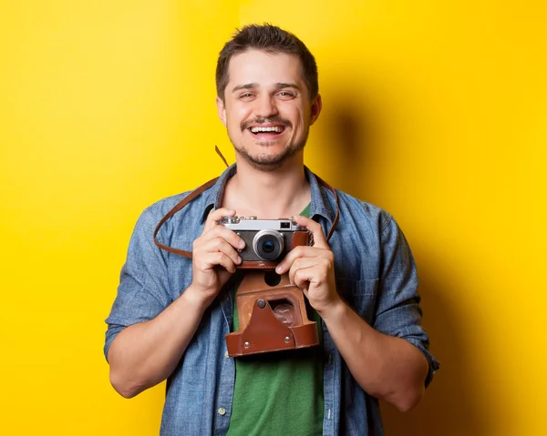 Guy in t-shirt with retro camera