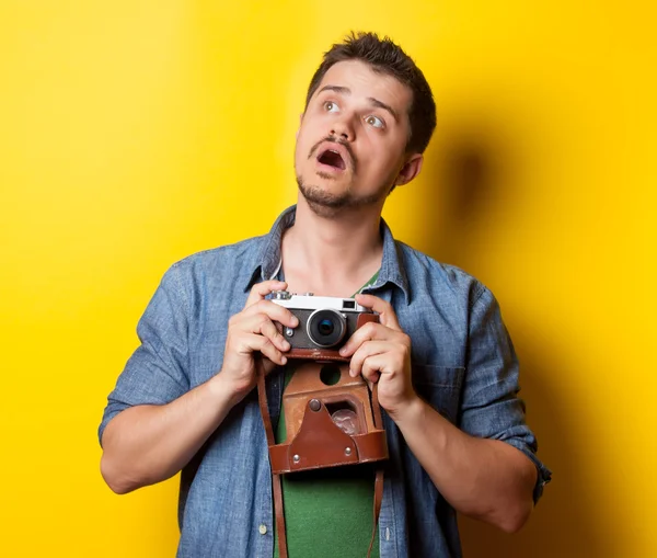 Guy in t-shirt with retro camera
