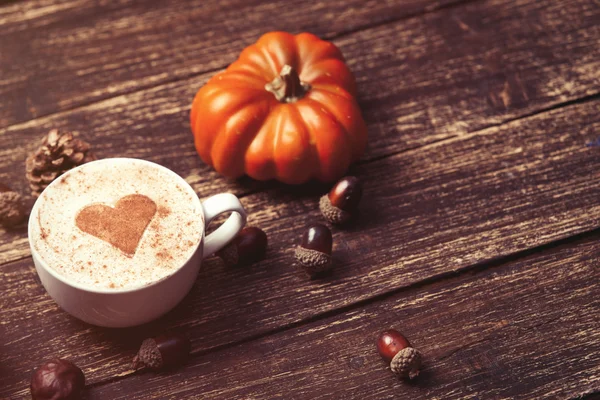 Cup and pine cone with acorn and pumpkin