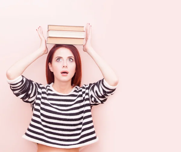 Woman with books above head