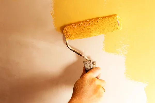 The process of painting the walls in yellow color