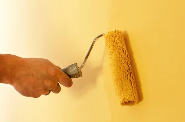 The process of painting the walls in yellow color