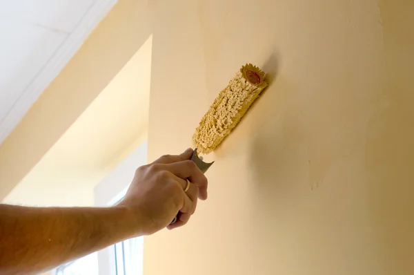 The process of painting the walls in yellow color
