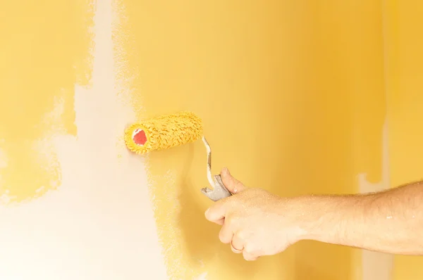 The process of painting the walls in yellow color