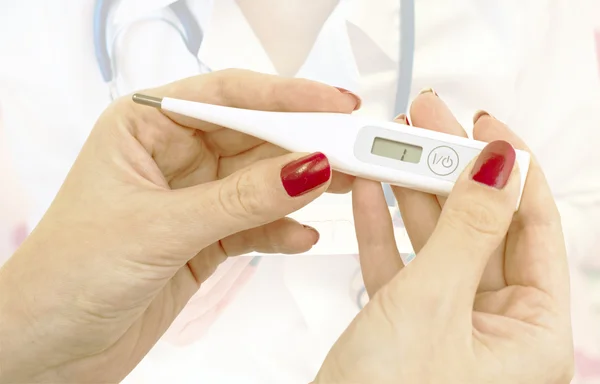 Electronic thermometer in hand