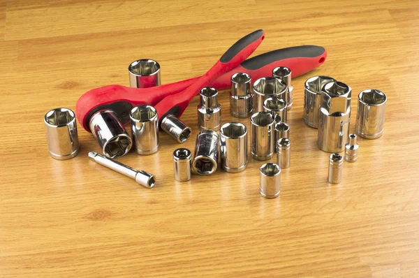 Ratchet and a set of different attachments to tighten the bolts